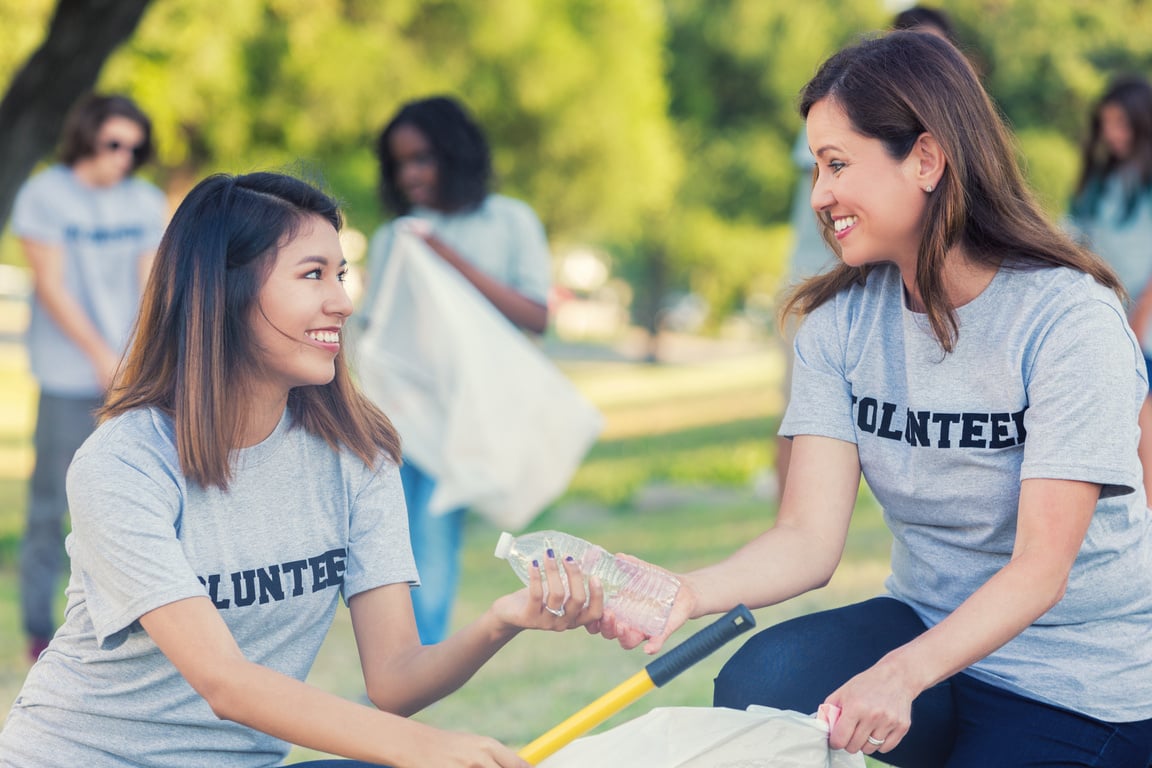 Community outreach volunteers picking up trash at a park